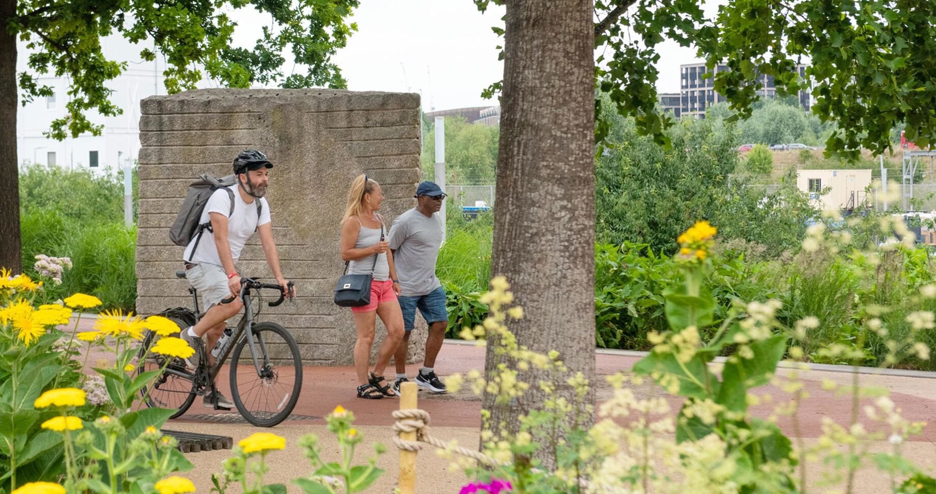 People walking and cycling through the park