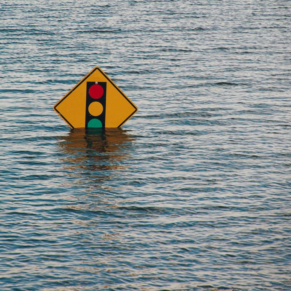 Road sign surrounded by water