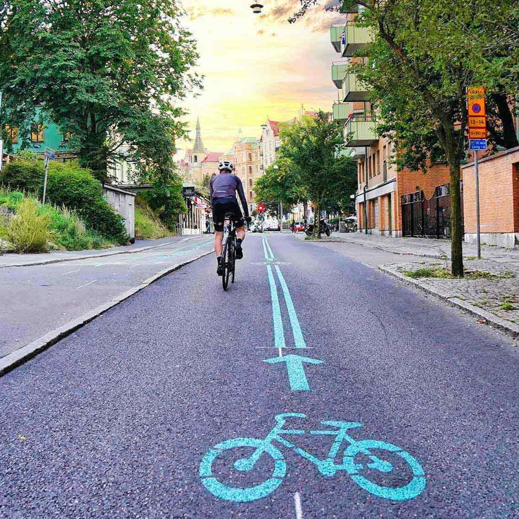 A cyclist in a dedicated cycle lane in a city