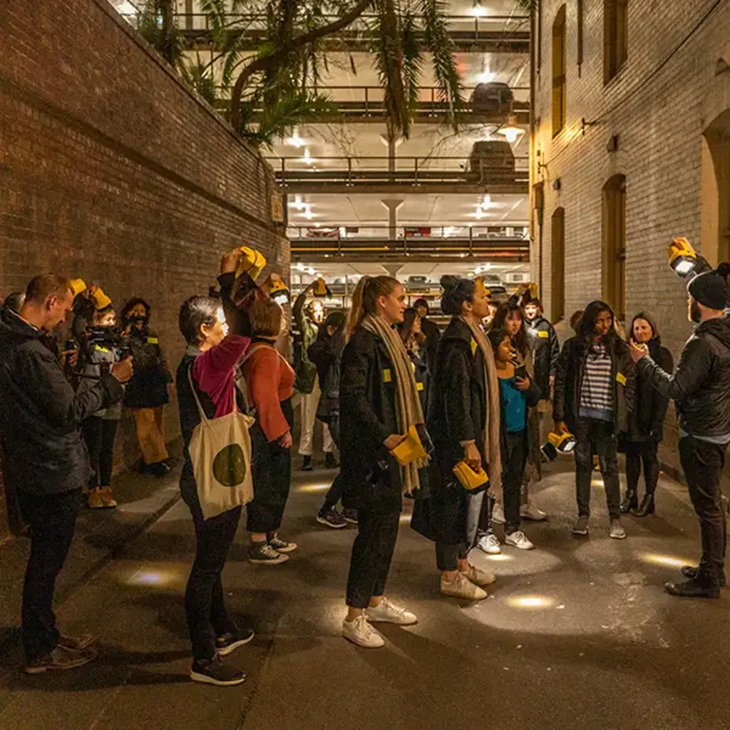 A group of people standing on a street.