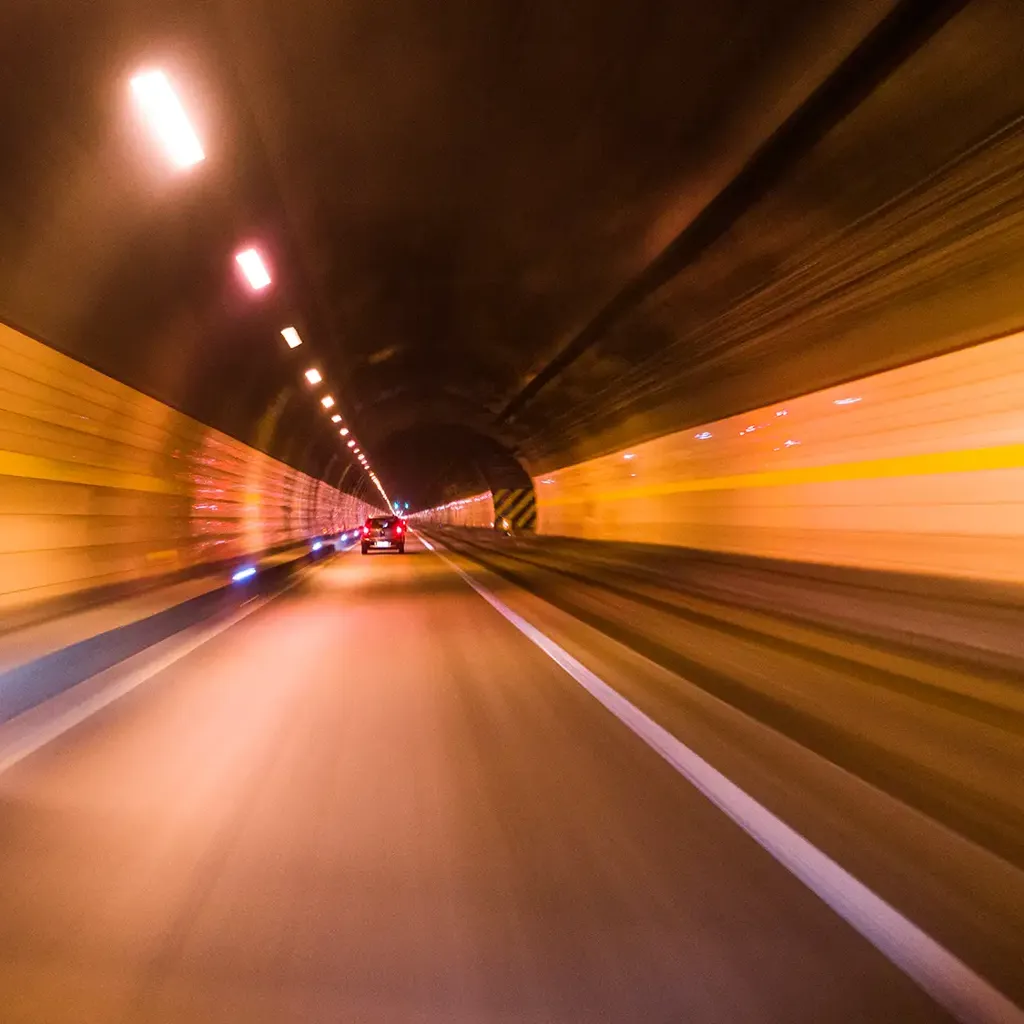 Car driving through tunnel