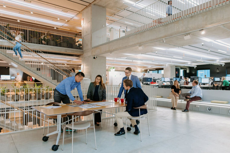 A group of people sitting at tables in Arup Sydney office