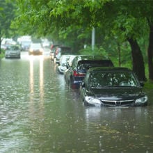 Flooded city street with cars semi submerged