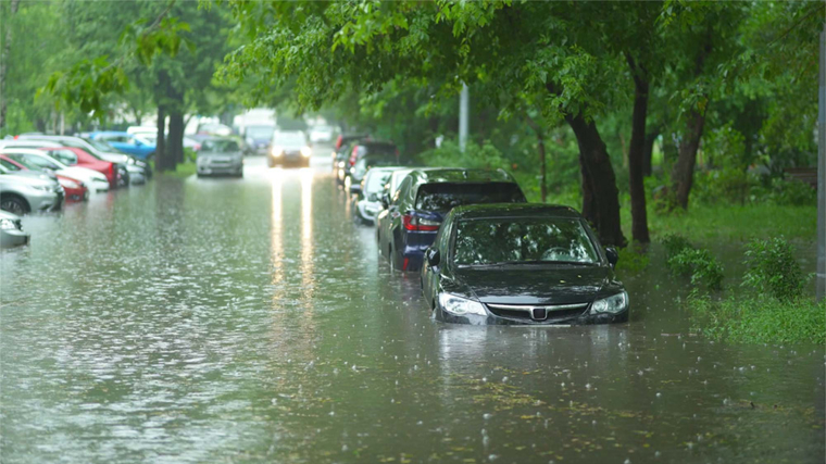 Flooded city street with cars semi submerged