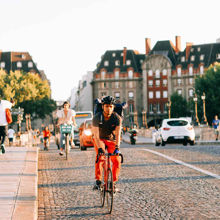People walking and cycling over a bridge
