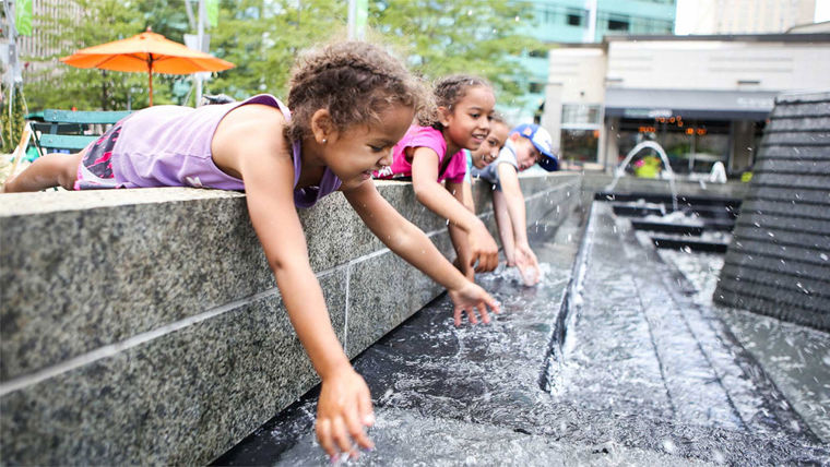 Children playing in a water fountain