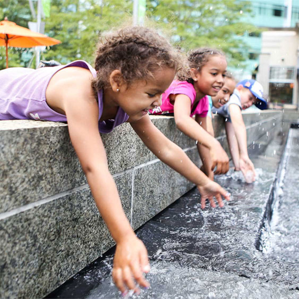 Children playing in a water fountain
