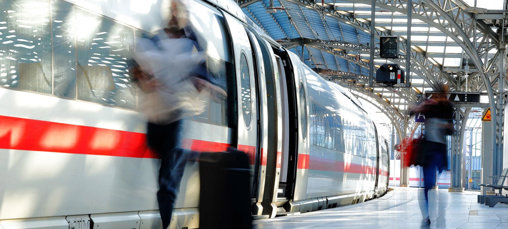 Train at a station with passengers on the platform