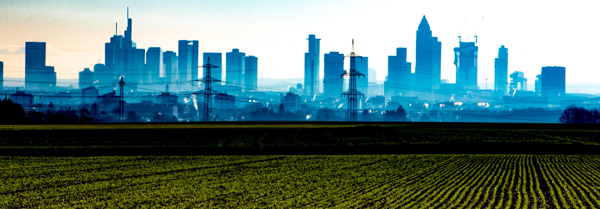 Farm in the foreground with a city in the background