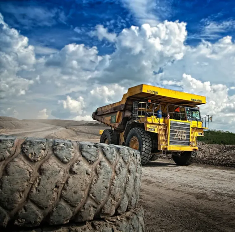 A mining truck in a dirt field.