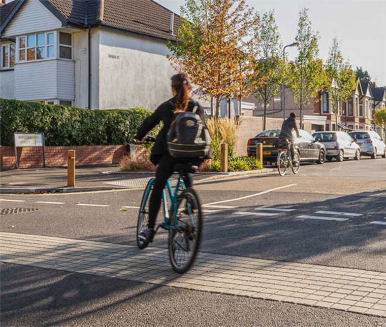 Cycling and walking on a street in Britain