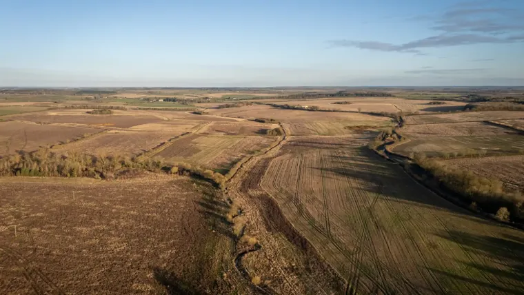 A large field with a road.