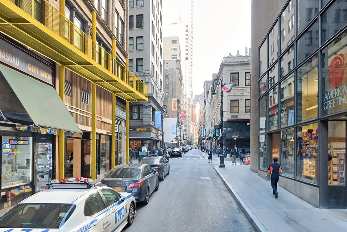 A street with cars and buildings on either side of it.