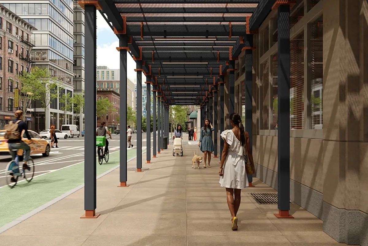 A person walking a dog on a sidewalk.