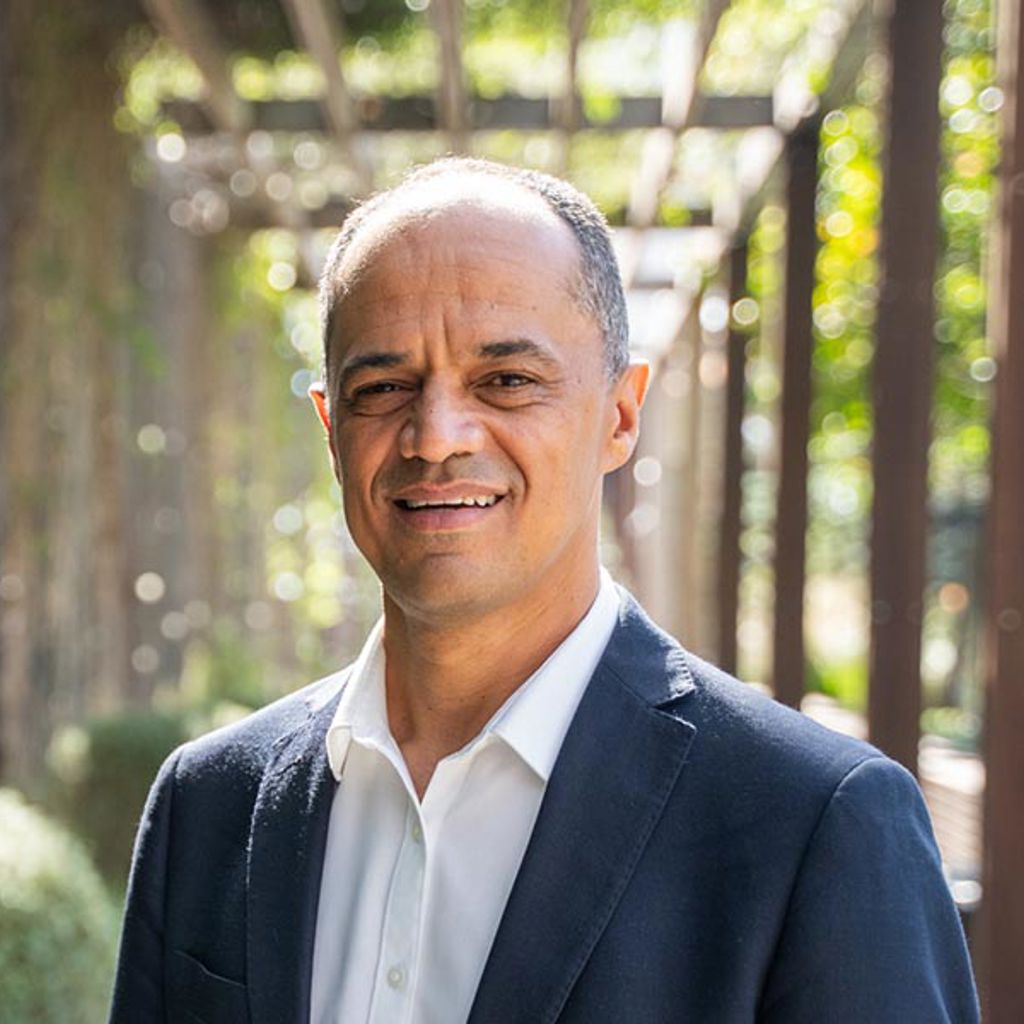 Paul Williams in a suit smiling