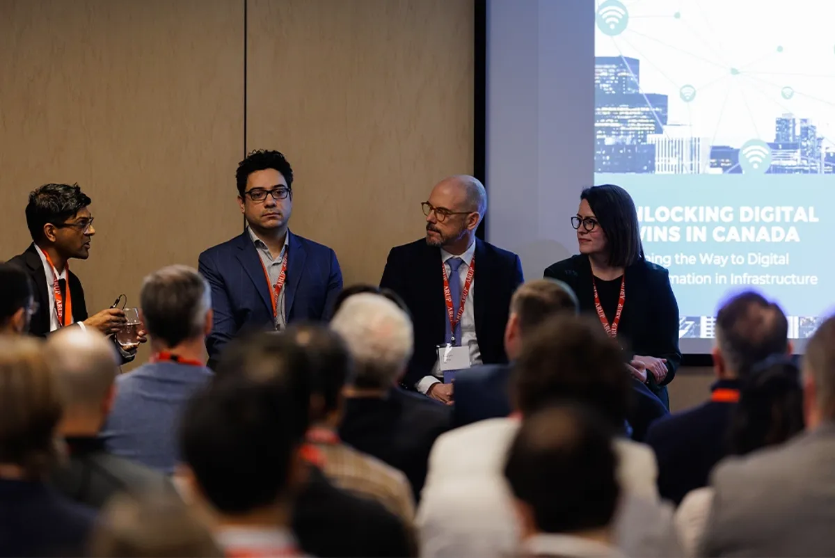 A group of people in a room watching a panel