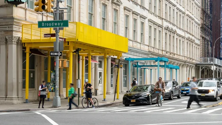 A street corner and building with colorful scaffolding sheds
