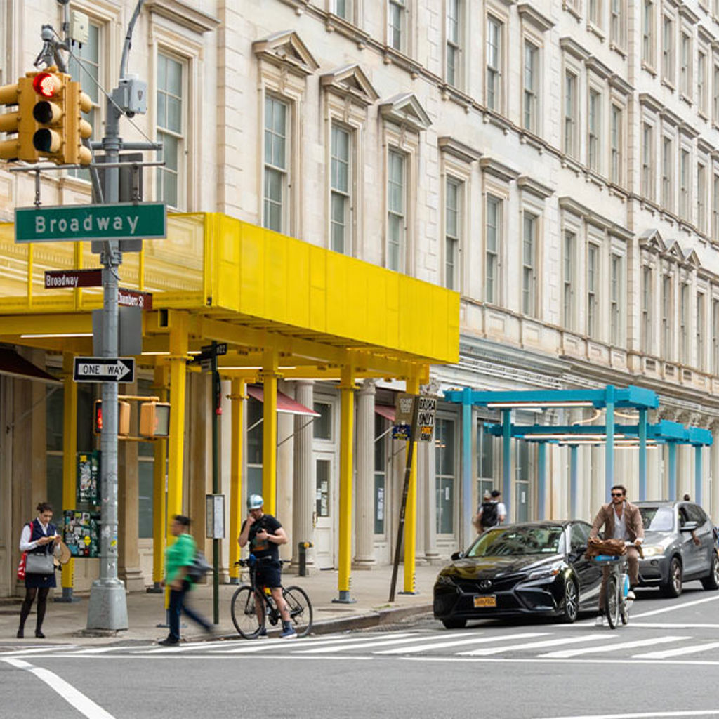 A street corner and building with colorful scaffolding sheds