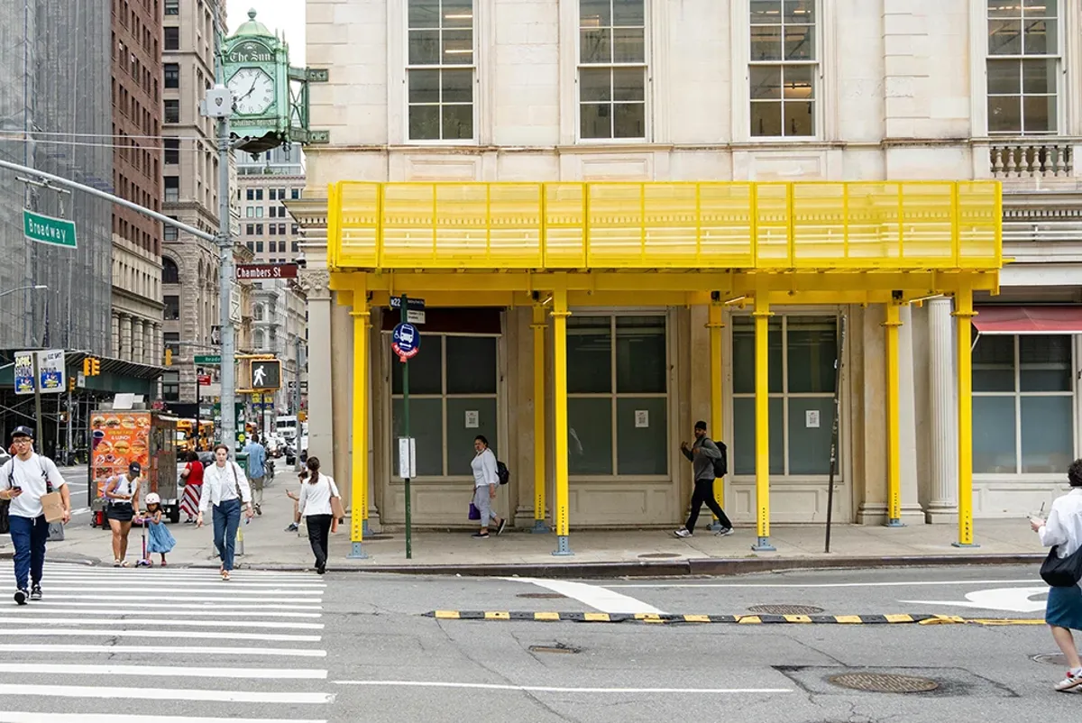 A building with a yellow scaffolding shed