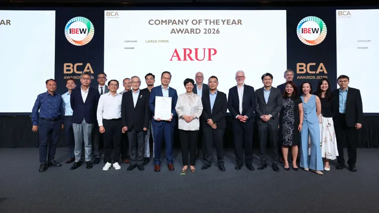 The Arup team group photo in front of the media wall displaying BCA Awards Company of the Year Arup