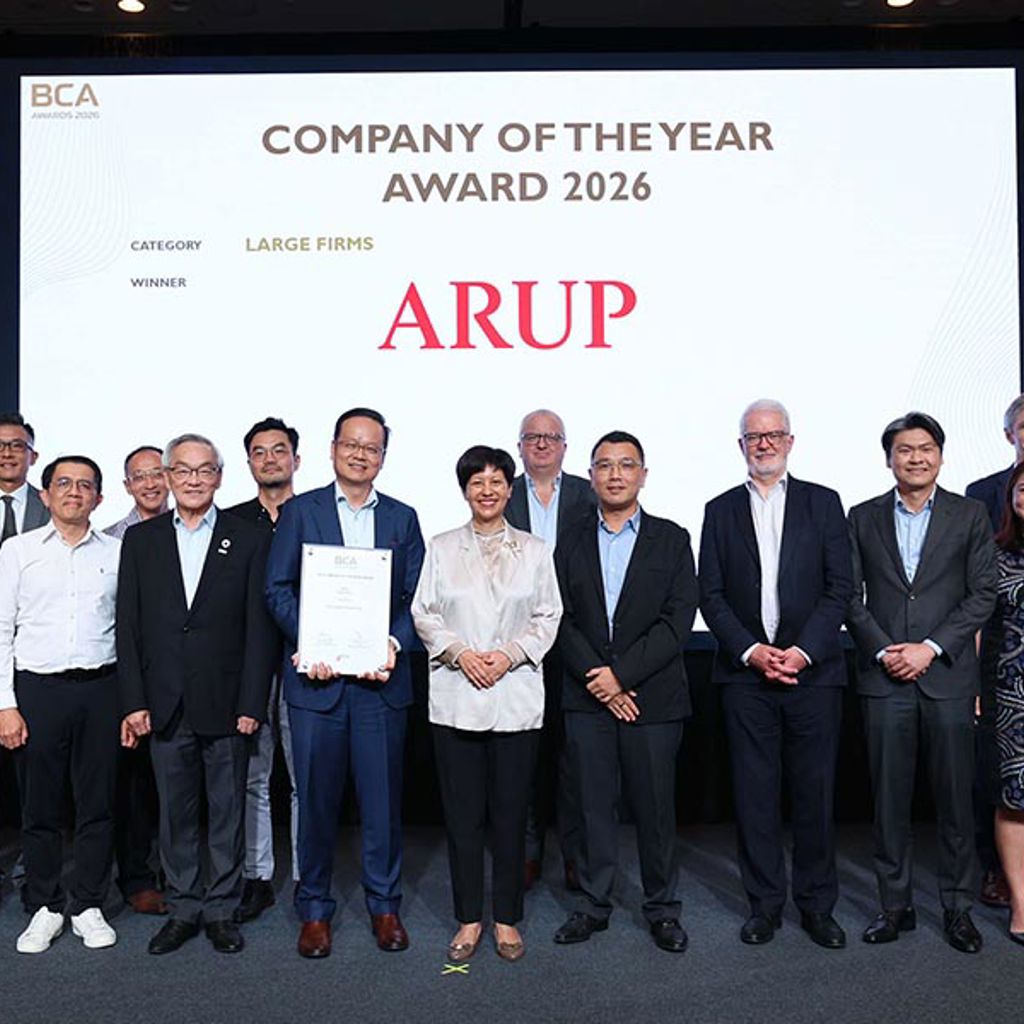 The Arup team group photo in front of the media wall displaying BCA Awards Company of the Year Arup