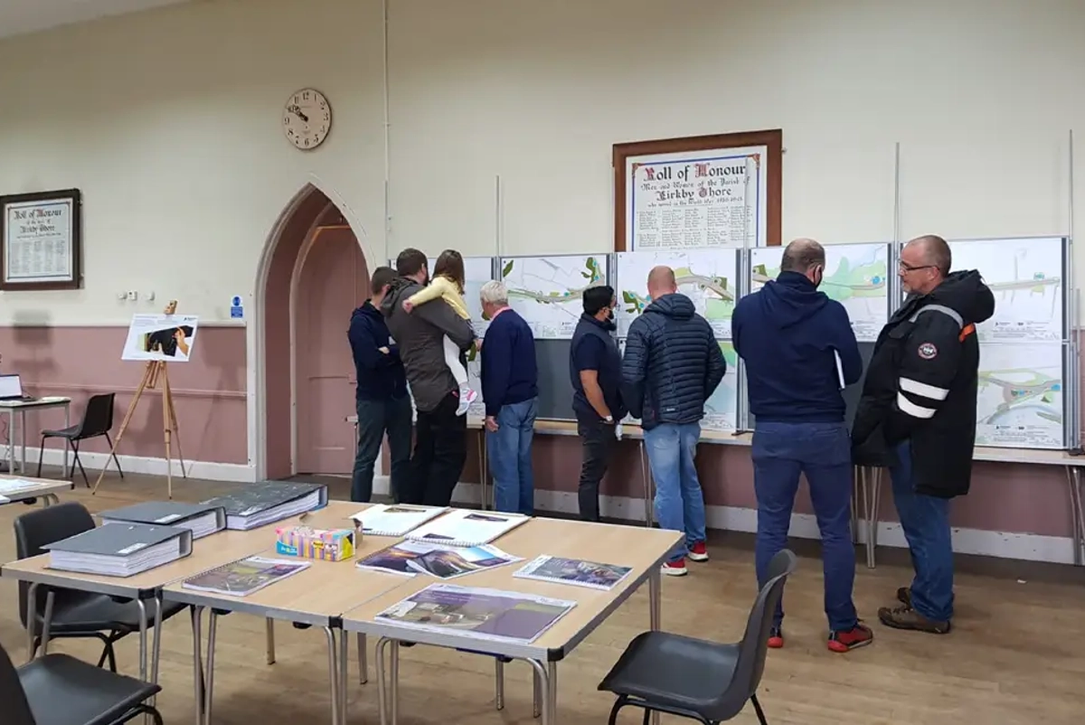 People looking at sketches at public consultation event at Kirby Thore venue