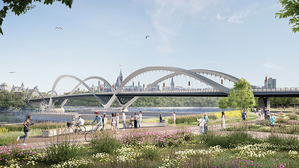 A group of people walking on a path by a bridge