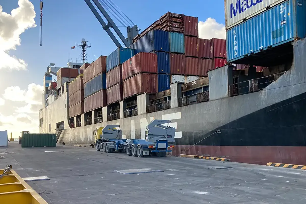 A large warehouse with a truck parked in front of it.