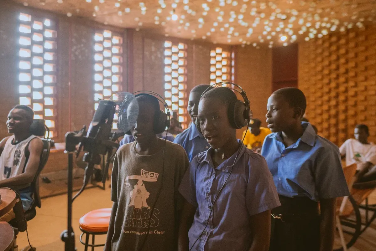 Children singing with recording equipment inside the Arts Centre