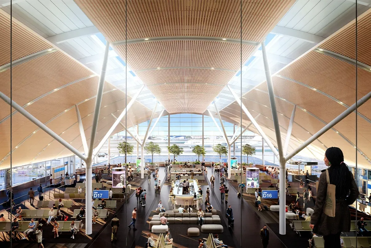 A large indoor terminal seen from above with seating and travelers