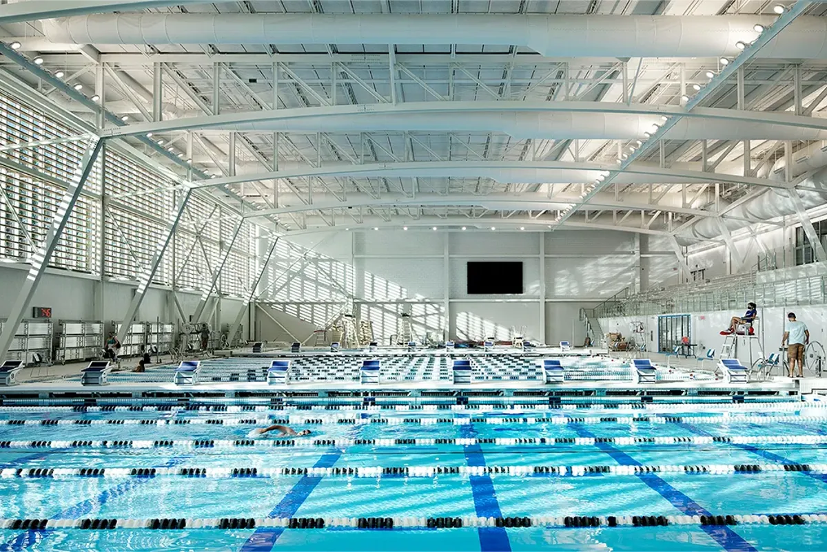 A swimming pool with people in it.