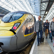 A Eurostar High Speed 1 train with passengers walking on the platform