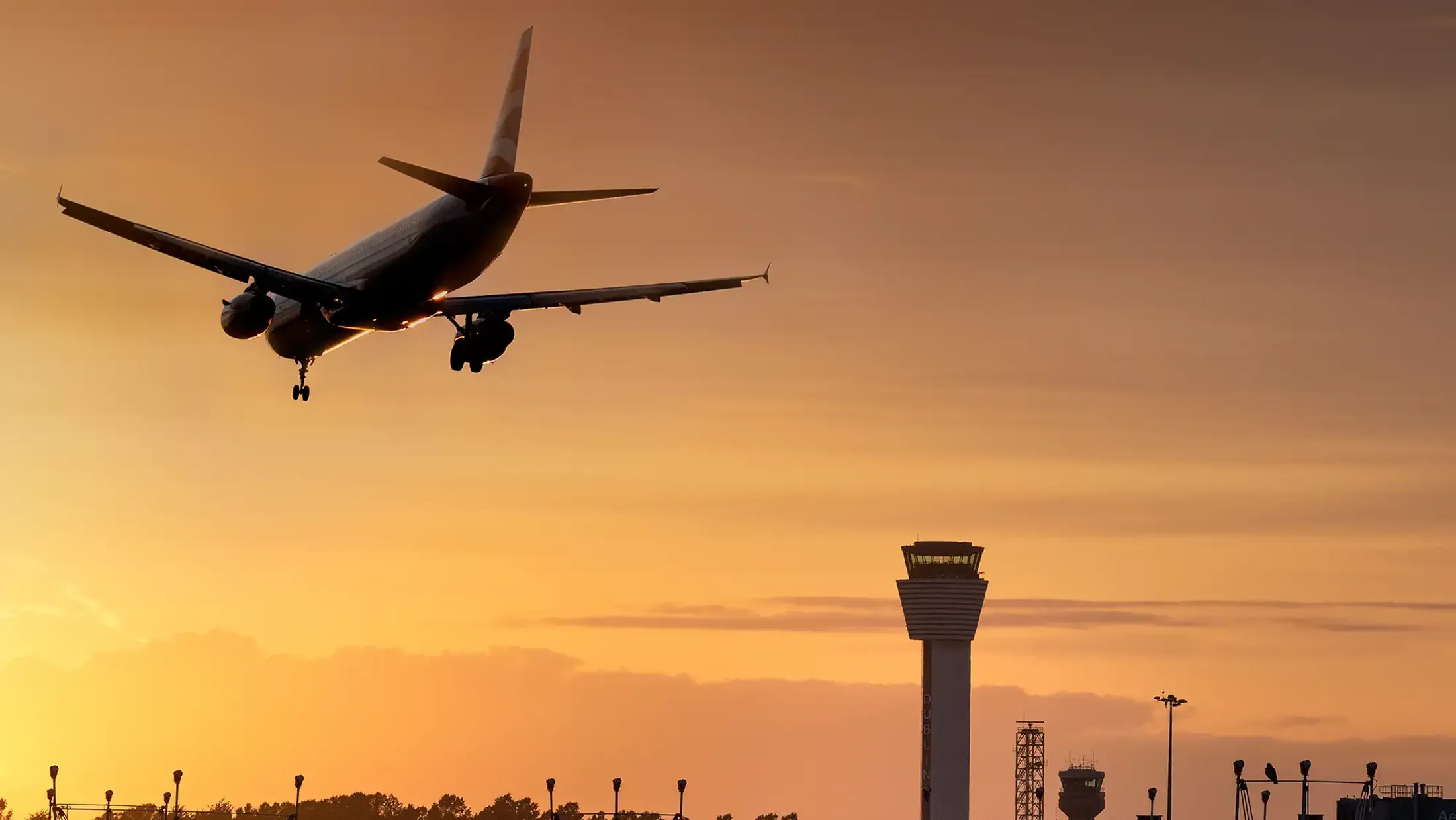 Plane flying above Dublin Airport Visual Control Tower