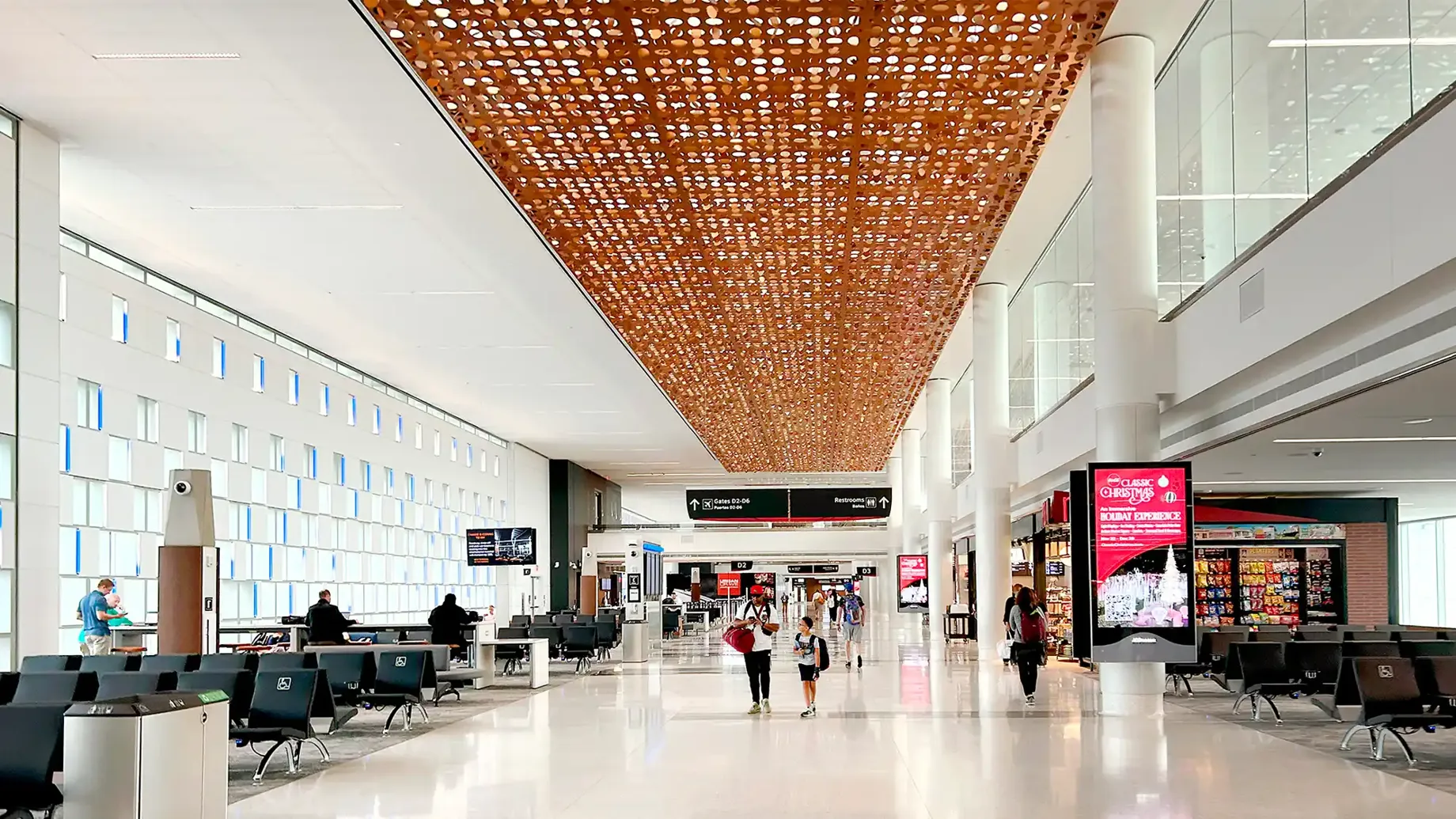 IAH Terminal D interior with a duo walking down the walkway