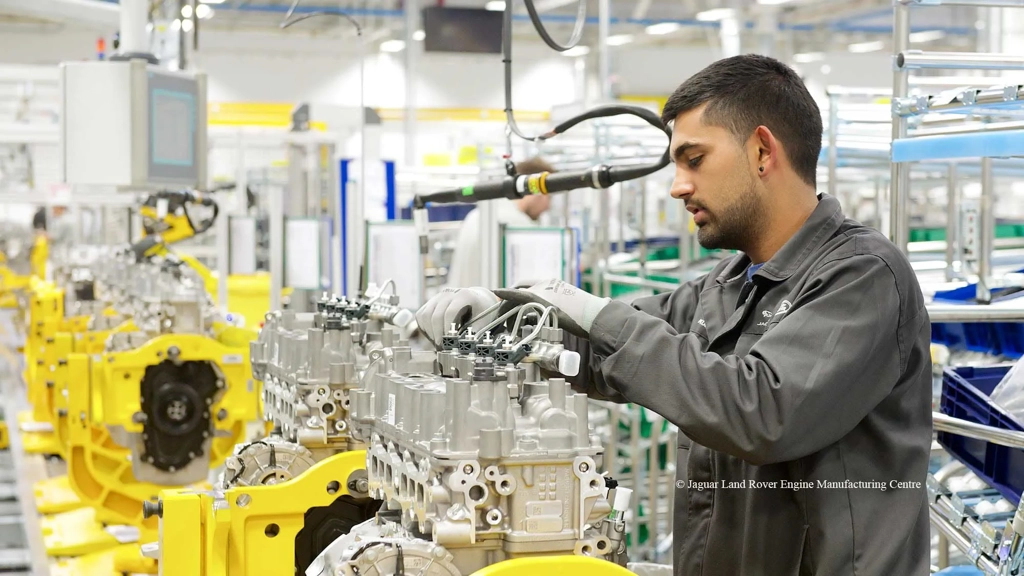 A man using machinery inside the JLR manufacturing facility