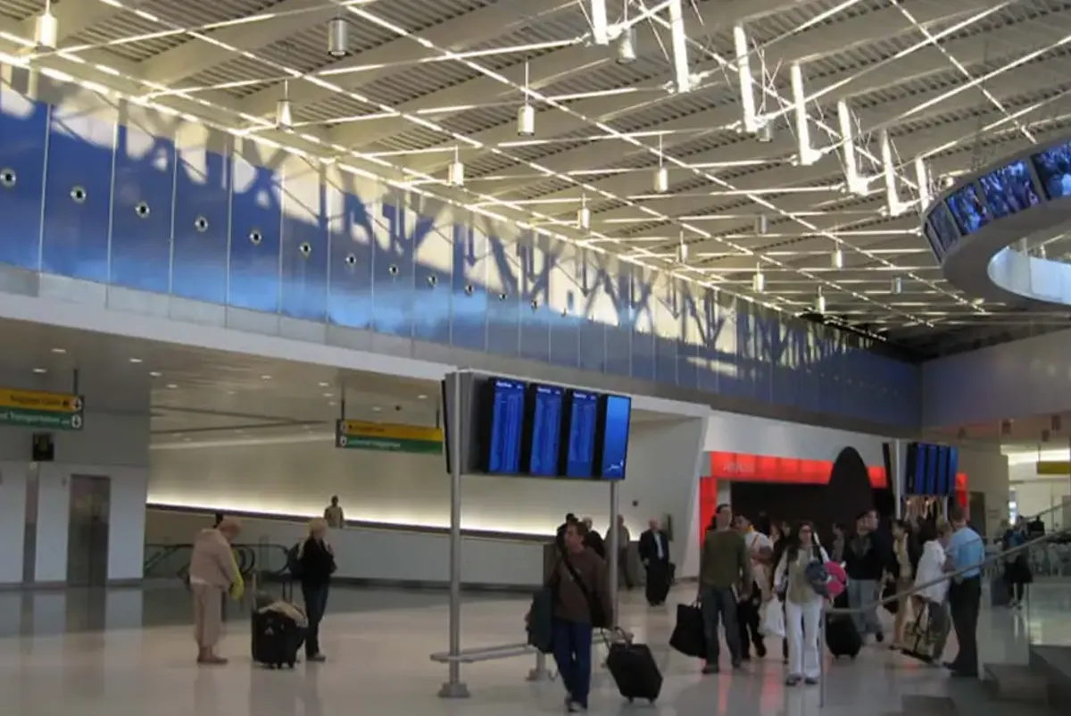 People with luggage in a terminal.