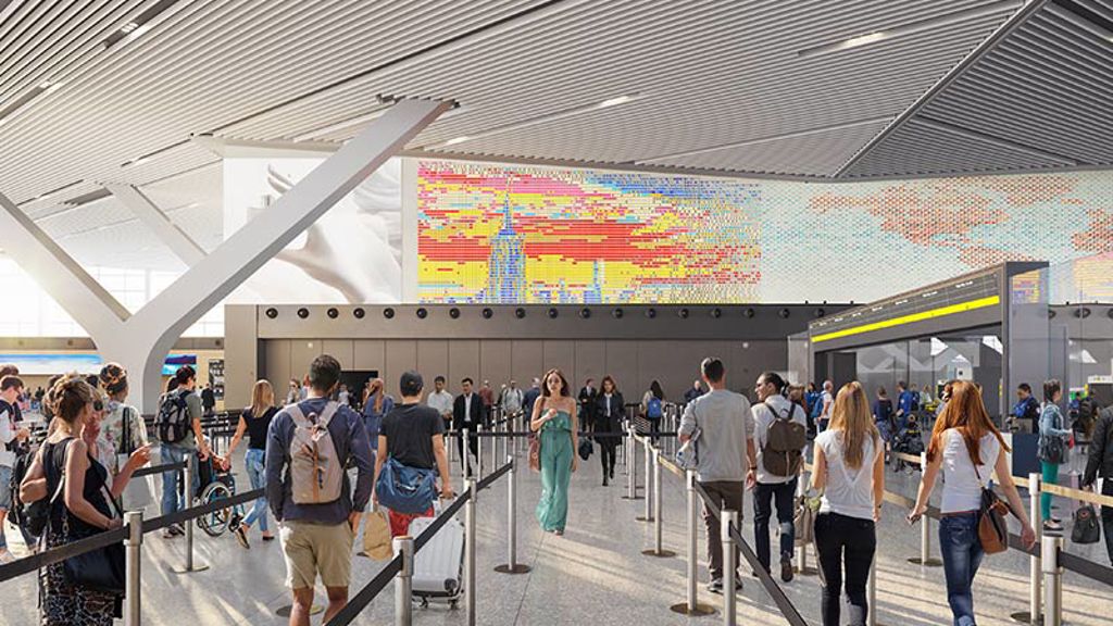 A group in line for airport security with digital display of New York City skyline above