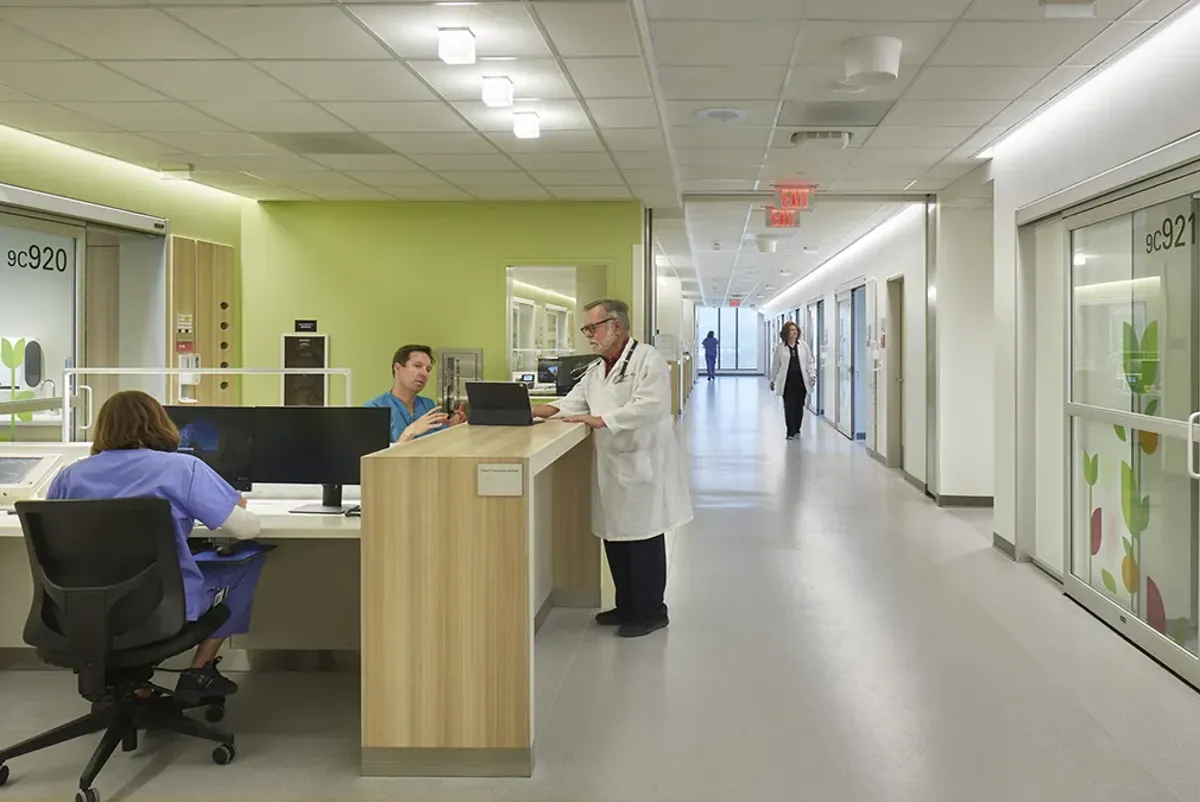 A group of people gathered around a hospital's front desk
