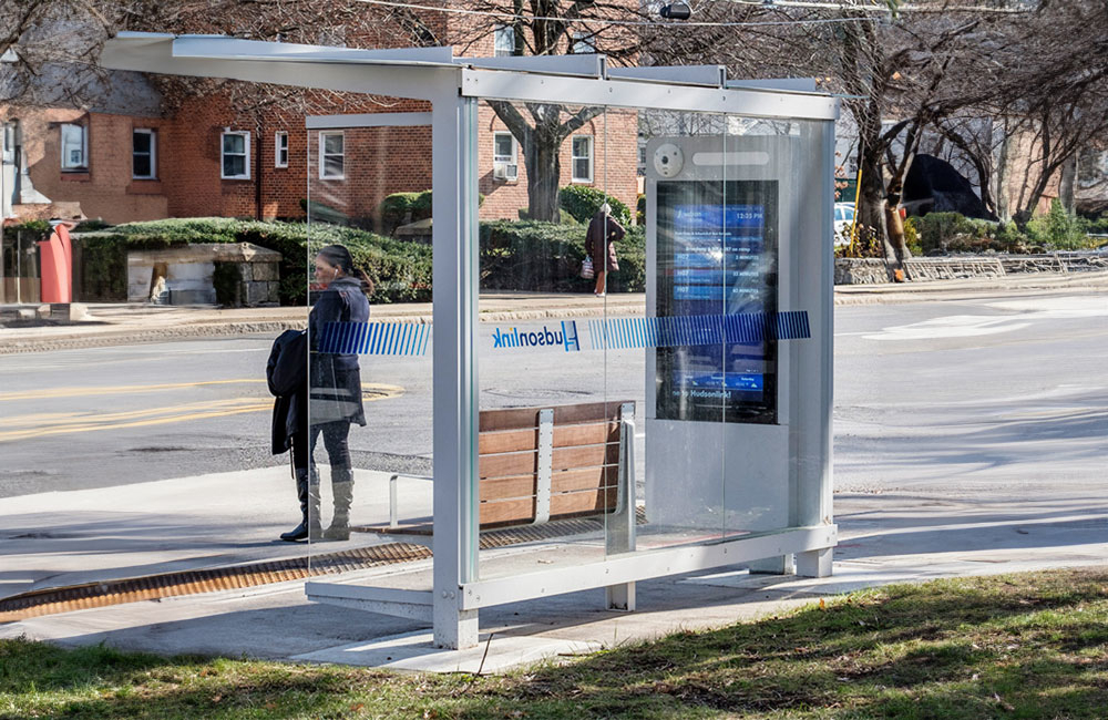 Woman standing at a bus stop