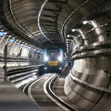 A train moving along the tracks inside a metro tunnel