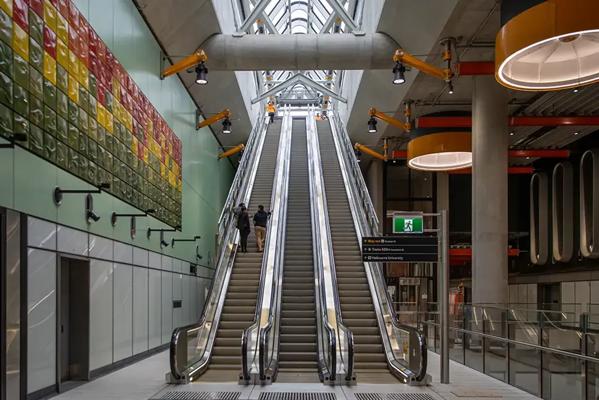 Large escalators take passengers up to street level at Parkville Station
