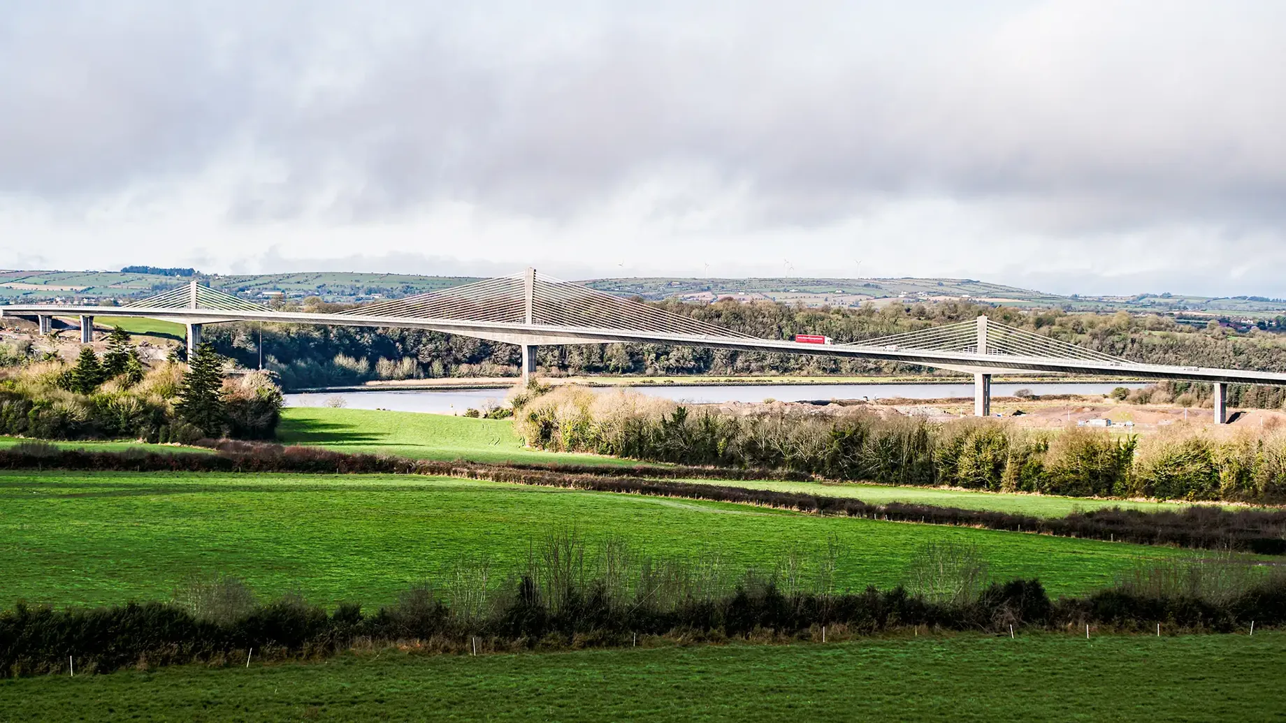 Lorry travelling across Rose Fitzgerald Kennedy Bridge with fields visible in foreground