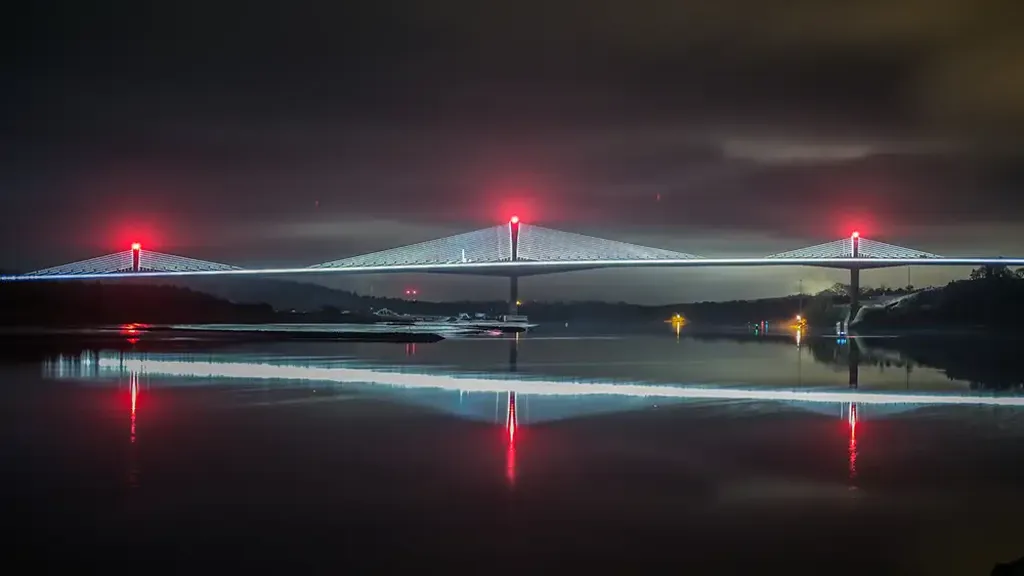 Rose Fitzgerald Kennedy Bridge lit up at night showing the reflection in the River Barrow
