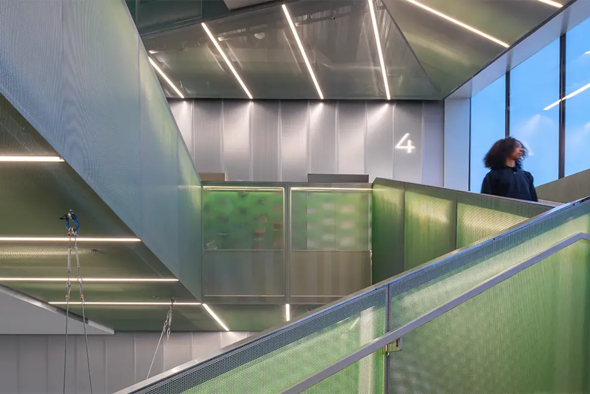 A person standing on a green staircase.