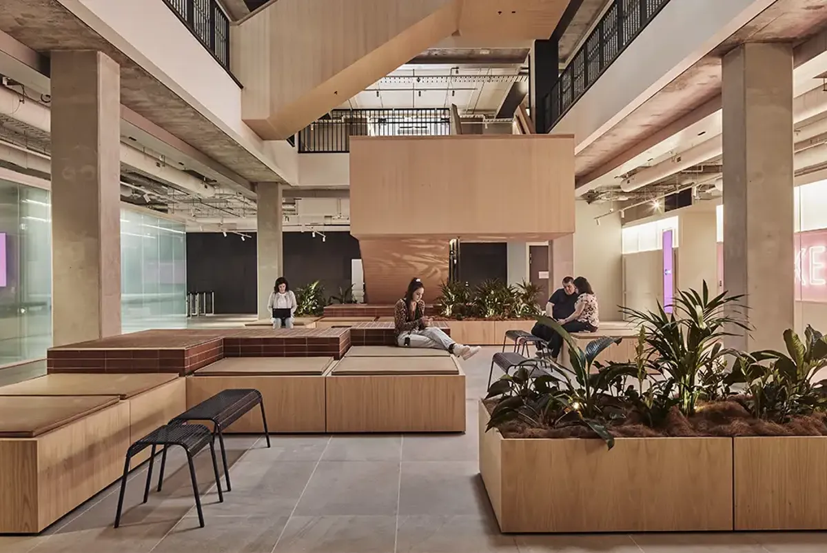 A large space with flexible seating, lounges, tables and plants