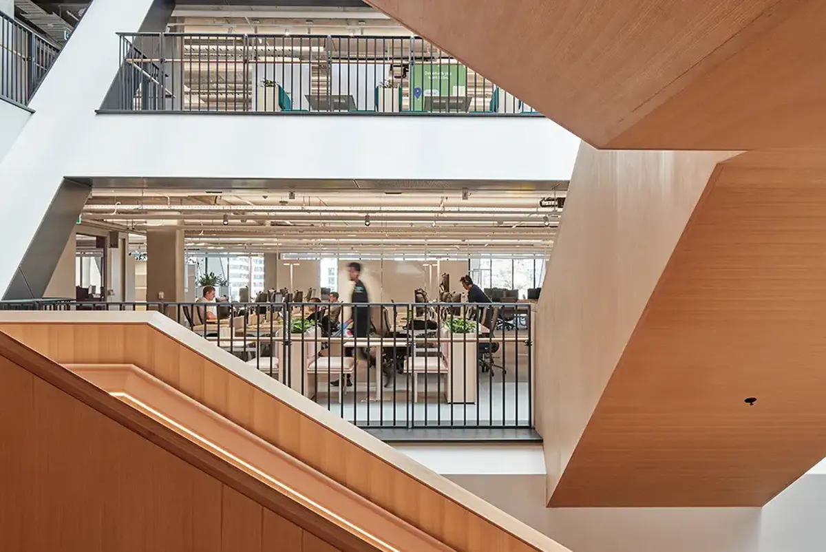 Open plan work spaces on each level connected by timber stairs