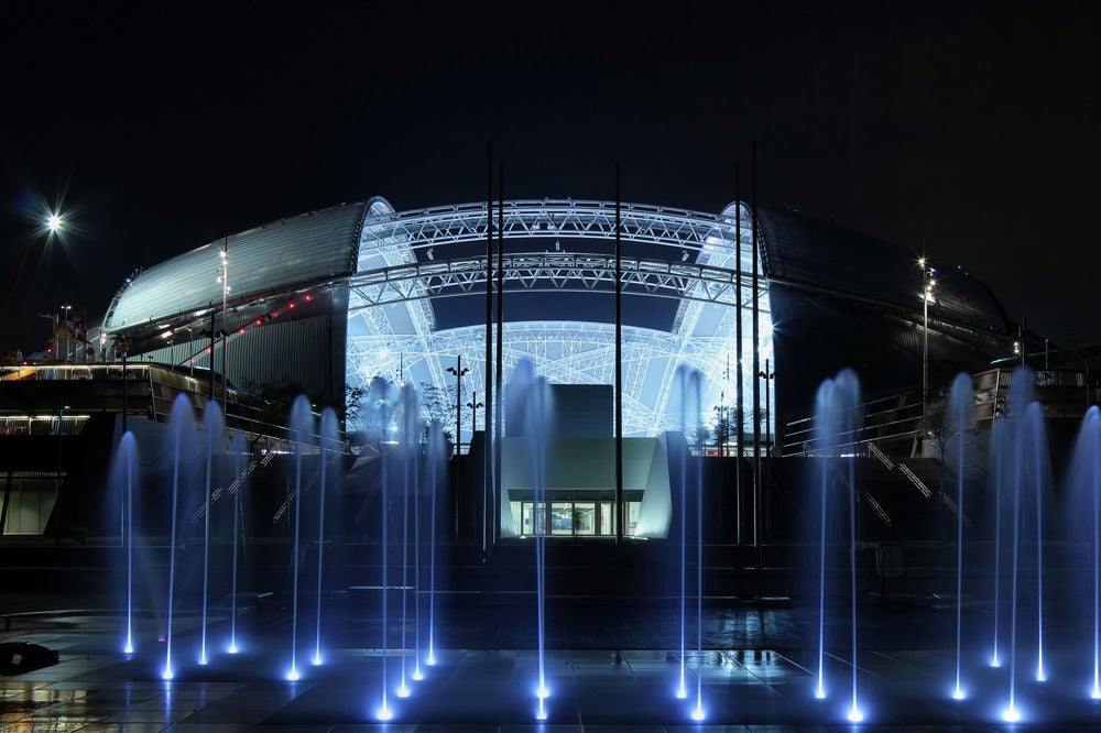 Singapore Sports Hub at night with fountains in the foreground