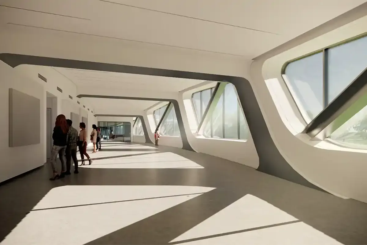 A group of people walking inside the Learning Center Pavilion
