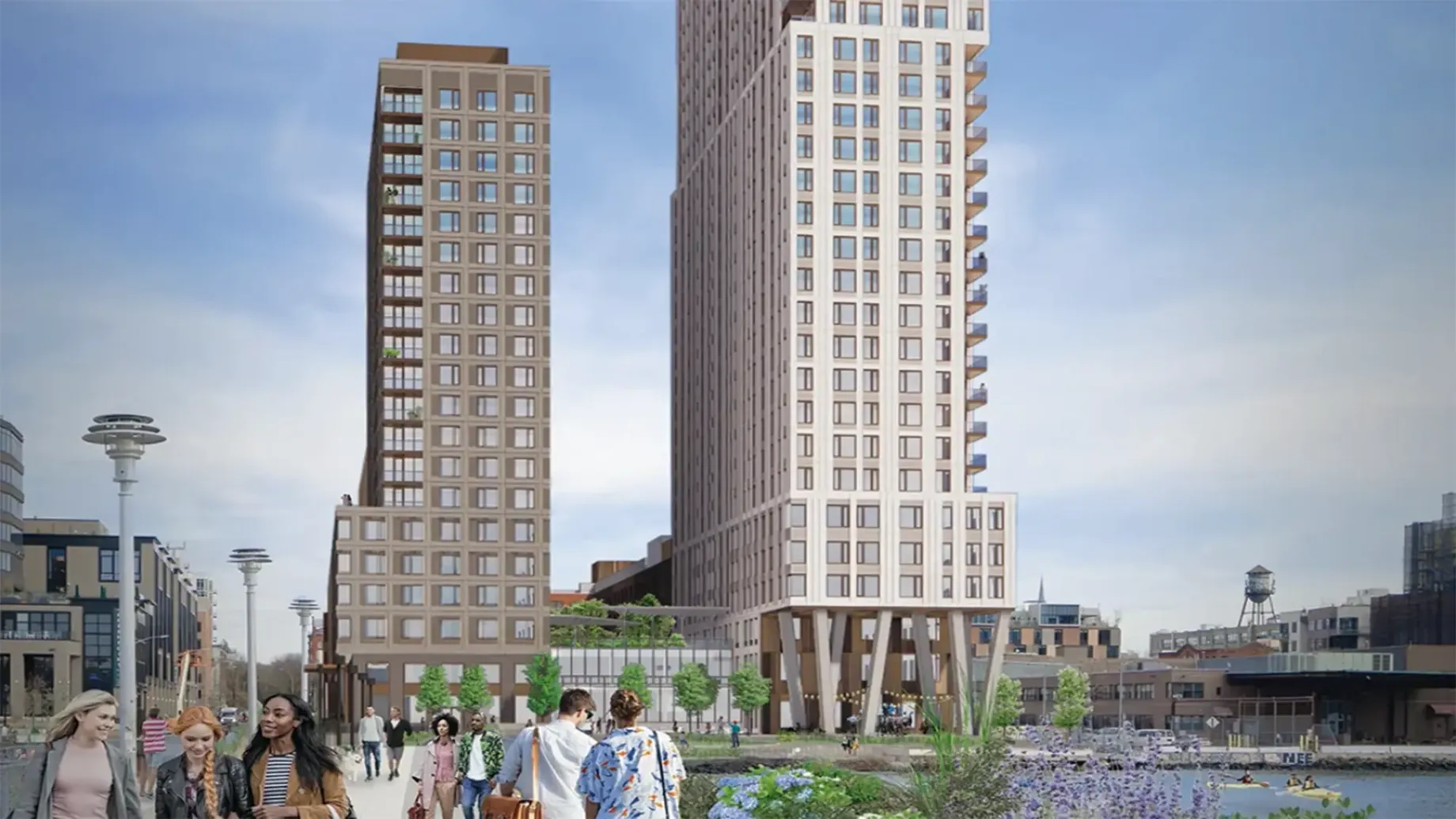 A group of people walking on a path between two tall buildings.
