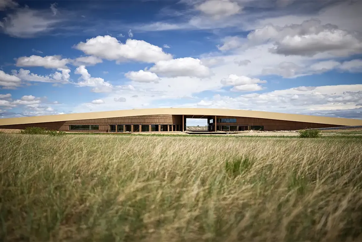 A building with a field in front of it.